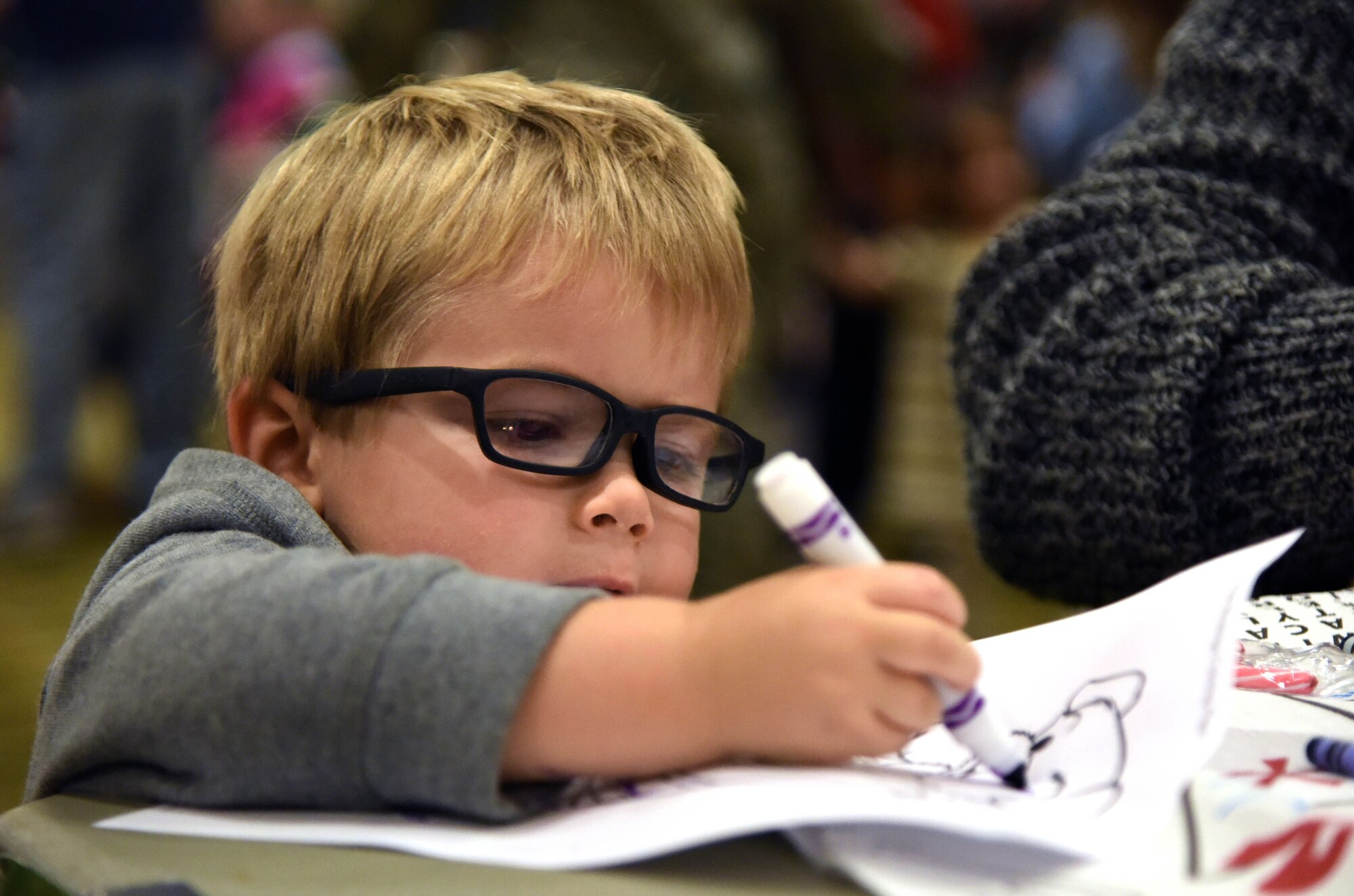 Ellis Easterling V, son of Capt. Ellis Easterling IV, 81st Medical Operations Squadron internal medicine physician, colors during Keesler’s annual Christmas celebration at the Bay Breeze Event Center Dec. 7, 2017, on Keesler Air Force Base, Mississippi. The event, hosted by Outdoor Recreation, included cookie decorating, games, gifts and visits with Santa. (U.S. Air Force photo by Kemberly Groue)