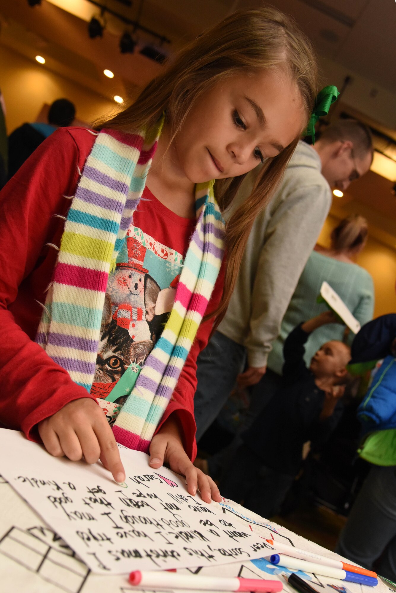 Sarah Hutton, daughter of Capt. Michael Hutton, 81st Medical Operations Squadron nurse practitioner, writes a letter to Santa during Keesler’s annual Christmas celebration at the Bay Breeze Event Center Dec. 7, 2017, on Keesler Air Force Base, Mississippi. The event, hosted by Outdoor Recreation, included cookie and ornament decorating, games and visits with Santa. (U.S. Air Force photo by Kemberly Groue)