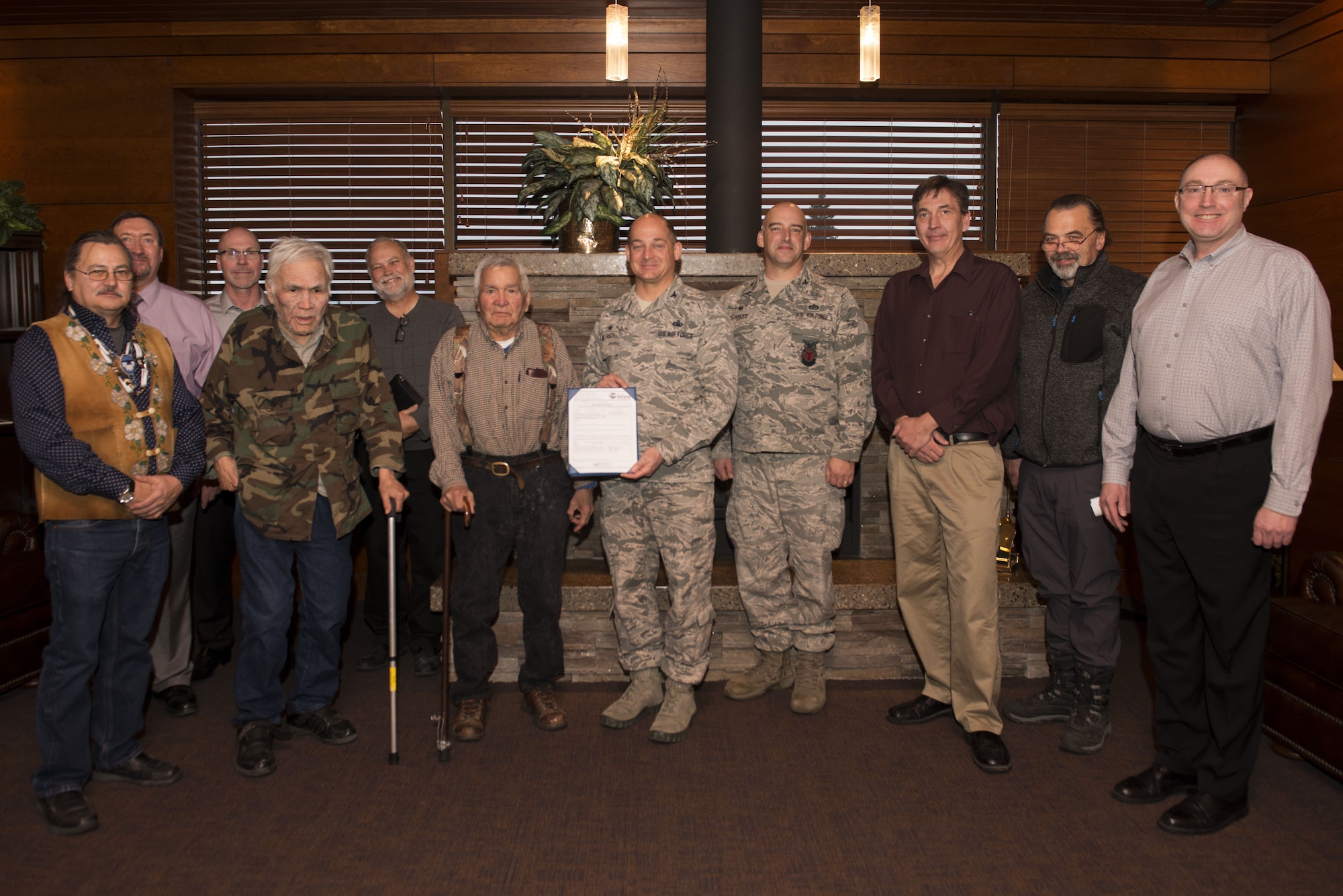Air Force Col. George Dietrich, 673d Air Base Wing and Joint Base Elmendorf-Richardson commander, and Gary Harrison, Chickaloon Native Village chief, and their representatives discuss and agree to a memorandum of agreement at the Arctic Warrior Events Center at JBER, Alaska, Dec. 5, 2017. The MOA served to establish a relationship between JBER and the CNV to converse on mutual concerns, support and coordinate management of resources.