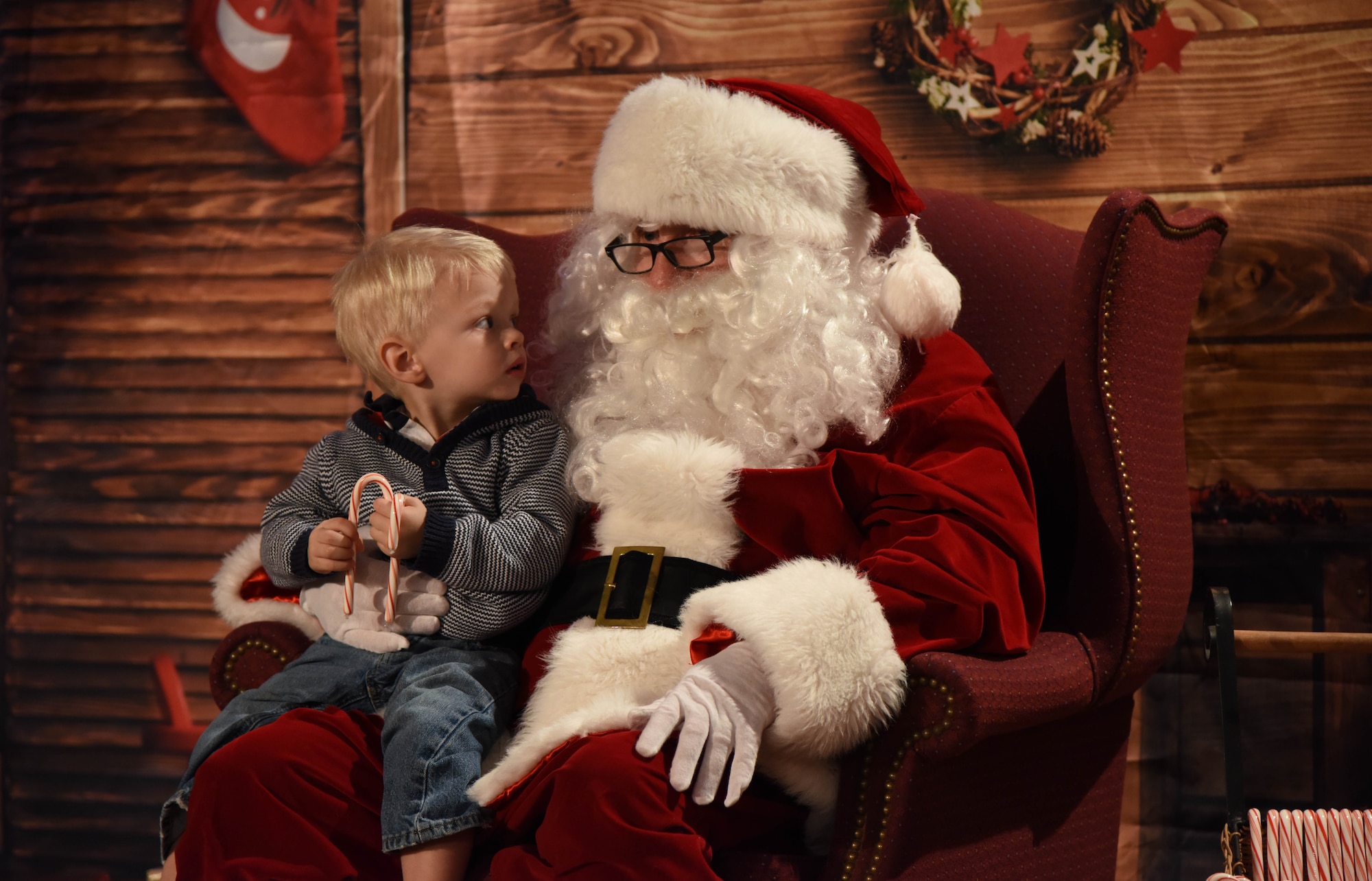 Brant Gilkison, son of Maj. Karin Gilkison, 81st Medical Operations Squadron gastroenterologist, visits with Santa during Keesler’s annual Christmas celebration at the Bay Breeze Event Center Dec. 7, 2017, on Keesler Air Force Base, Mississippi. The event, hosted by Outdoor Recreation, included cookie and ornament decorating, games and visits with Santa. (U.S. Air Force photo by Kemberly Groue)
