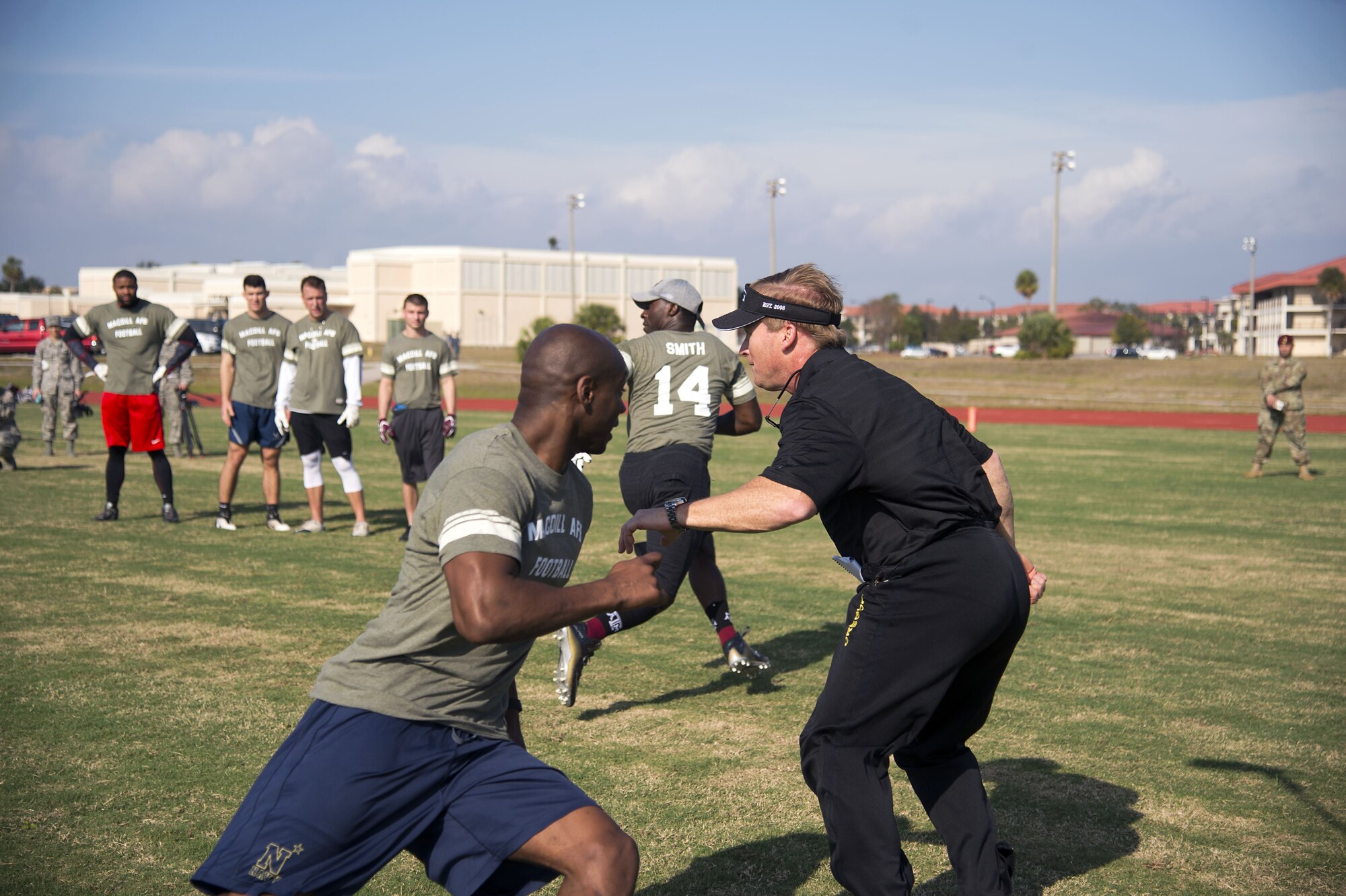 Jon Gruden, a Monday Night Football color analyst, plays defense during a football camp held at MacDill Air Force Base, Fla., Dec. 8, 2017. Gruden taught the participants various plays and how to execute them correctly.