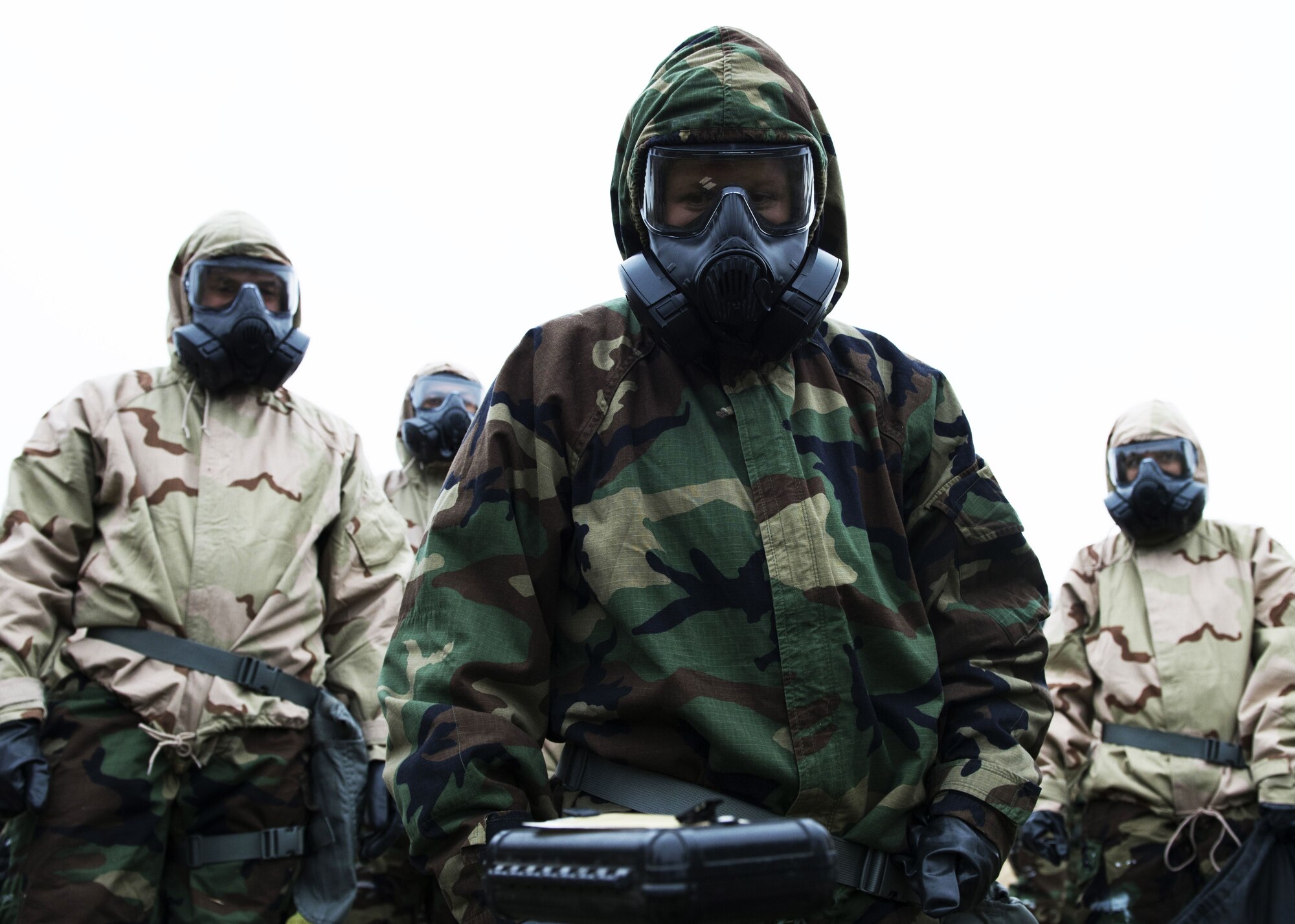 Airmen clad in full chemical warfare protective equipment analyze a post attack reconnaissance stand during an exercise at Fairchild Air Force Base, Washington, Nov. 30, 2017. PAR stands are one of many detection tools used to show evidence of harmful chemical agents. (U.S. Air Force Photo/ Senior Airman Ryan Lackey)