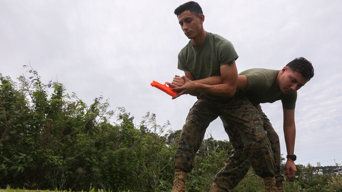 Cpl. Javier Carpintero performs a Marine Corps Martial Arts Program (MCMAP) technique on a student on Camp Courtney, Okinawa, Dec. 7, 2017. The purpose of MCMAP is to train Marines on combat skills that may be used in real-life scenarios.