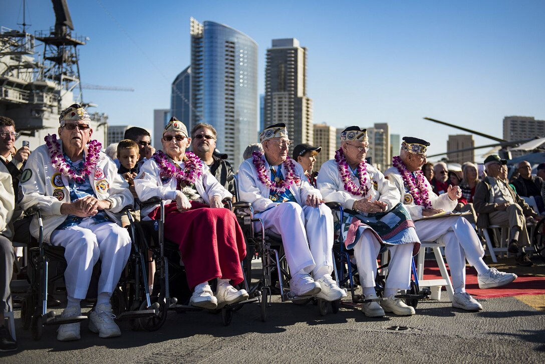 Pearl Harbor survivors watch a Pearl Harbor Day commemoration.