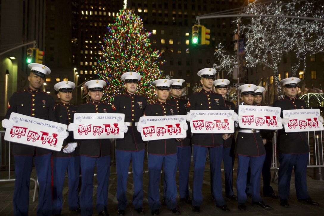 Marines stand in line holding signs