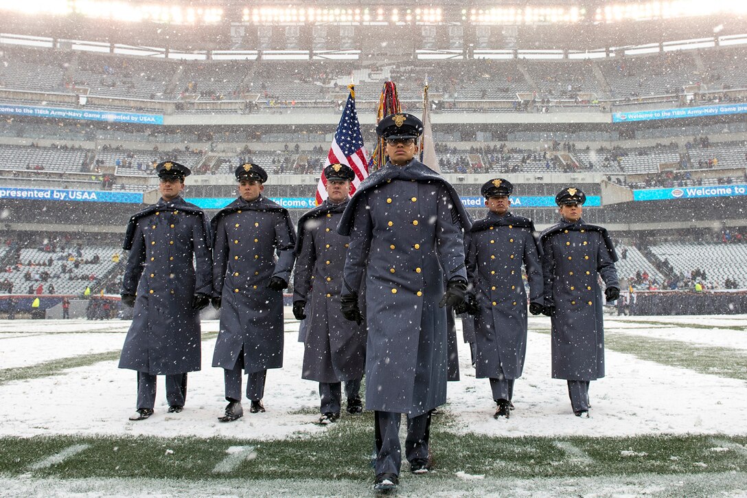Soldiers march on the field before the game starts.
