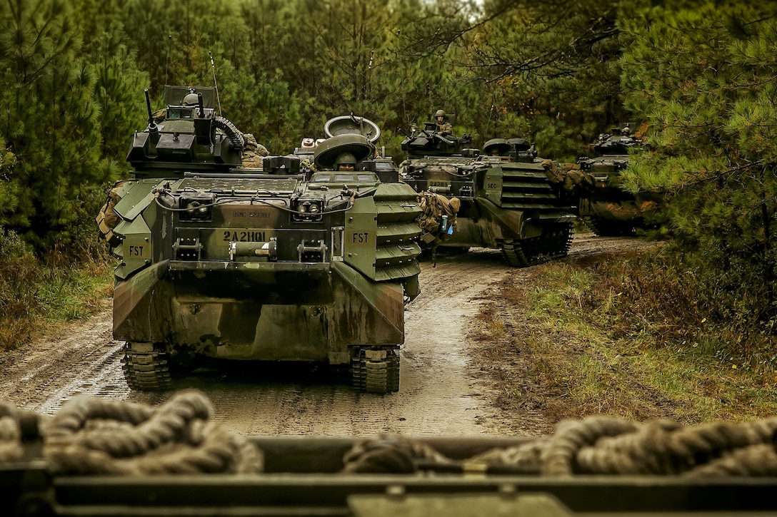 U.S. Marine Corps AAV-P7/A1 assault amphibious vehicles
 with Fox Company, Battalion Landing Team, 2nd Battalion, 6th Marine Regiment, 26th Marine Expeditionary Unit (MEU), move in a formation during a mechanized raid at Camp Lejeune, N.C., Dec. 7, 2017, to complete Combined Composite Training Unit Exercise (COMPTUEX). Combined COMPTUEX allows all elements of the Marine Air Ground Task Force to join and train in realistic scenarios so the MEU as a whole can meet its Predeployment Training Program objectives prior to an upcoming deployment at sea. (U.S. Marine Corps photo by Staff Sgt. Dengrier M. Baez)