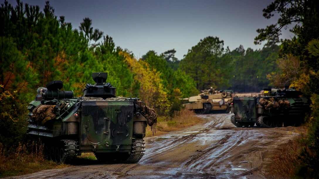 U.S. Marine Corps AAV-P7/A1 assault amphibious vehicles and an M1A1 Abrams tank with Fox Company, Battalion Landing Team, 2nd Battalion, 6th Marine Regiment, 26th Marine Expeditionary Unit (MEU), establish a security position during a mechanized raid at Camp Lejeune, N.C., Dec. 7, 2017, to complete Combined Composite Training Unit Exercise (COMPTUEX). Combined COMPTUEX allows all elements of the Marine Air Ground Task Force to join and train in realistic scenarios so the MEU as a whole can meet its Predeployment Training Program objectives prior to an upcoming deployment at sea. (U.S. Marine Corps photo by Staff Sgt. Dengrier M. Baez)