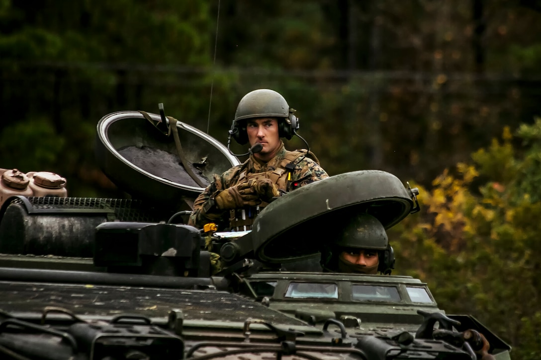 U.S. Marine Corps Capt. Joseph P. Murphy, top, commanding officer of Fox Company, Battalion Landing Team, 2nd Battalion, 6th Marine Regiment, 26th Marine Expeditionary Unit (MEU), looks on to his unit during a mechanized raid at Camp Lejeune, N.C., Dec. 7, 2017, to complete Combined Composite Training Unit Exercise (COMPTUEX). Combined COMPTUEX allows all elements of the Marine Air Ground Task Force to join and train in realistic scenarios so the MEU as a whole can meet its Predeployment Training Program objectives prior to an upcoming deployment at sea. (U.S. Marine Corps photo by Staff Sgt. Dengrier M. Baez)