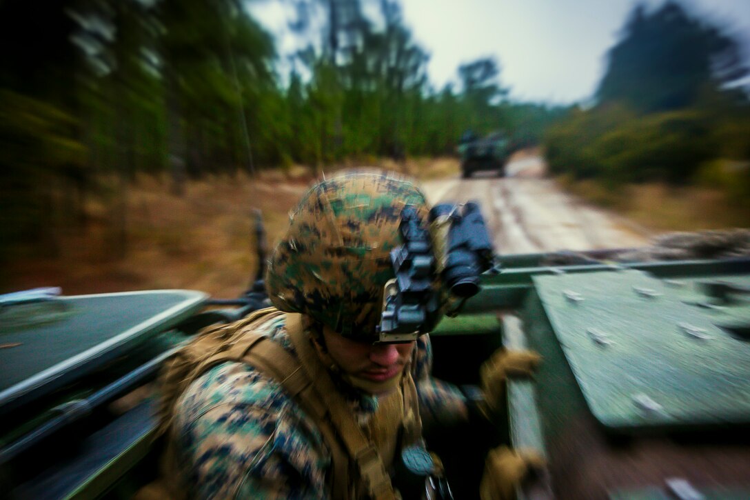 U.S. Marine Corps Lance Cpl. Matthew Maniet, a squad leader with Fox Company, Battalion Landing Team, 2nd Battalion, 6th Marine Regiment, 26th Marine Expeditionary Unit (MEU), stands up in an AAV-P7/A1 assault amphibious vehicle to provide security during a mechanized raid at Camp Lejeune, N.C., Dec. 7, 2017, to complete Combined Composite Training Unit Exercise (COMPTUEX). Combined COMPTUEX allows all elements of the Marine Air Ground Task Force to join and train in realistic scenarios so the MEU as a whole can meet its Predeployment Training Program objectives prior to an upcoming deployment at sea. (U.S. Marine Corps photo by Staff Sgt. Dengrier M. Baez)