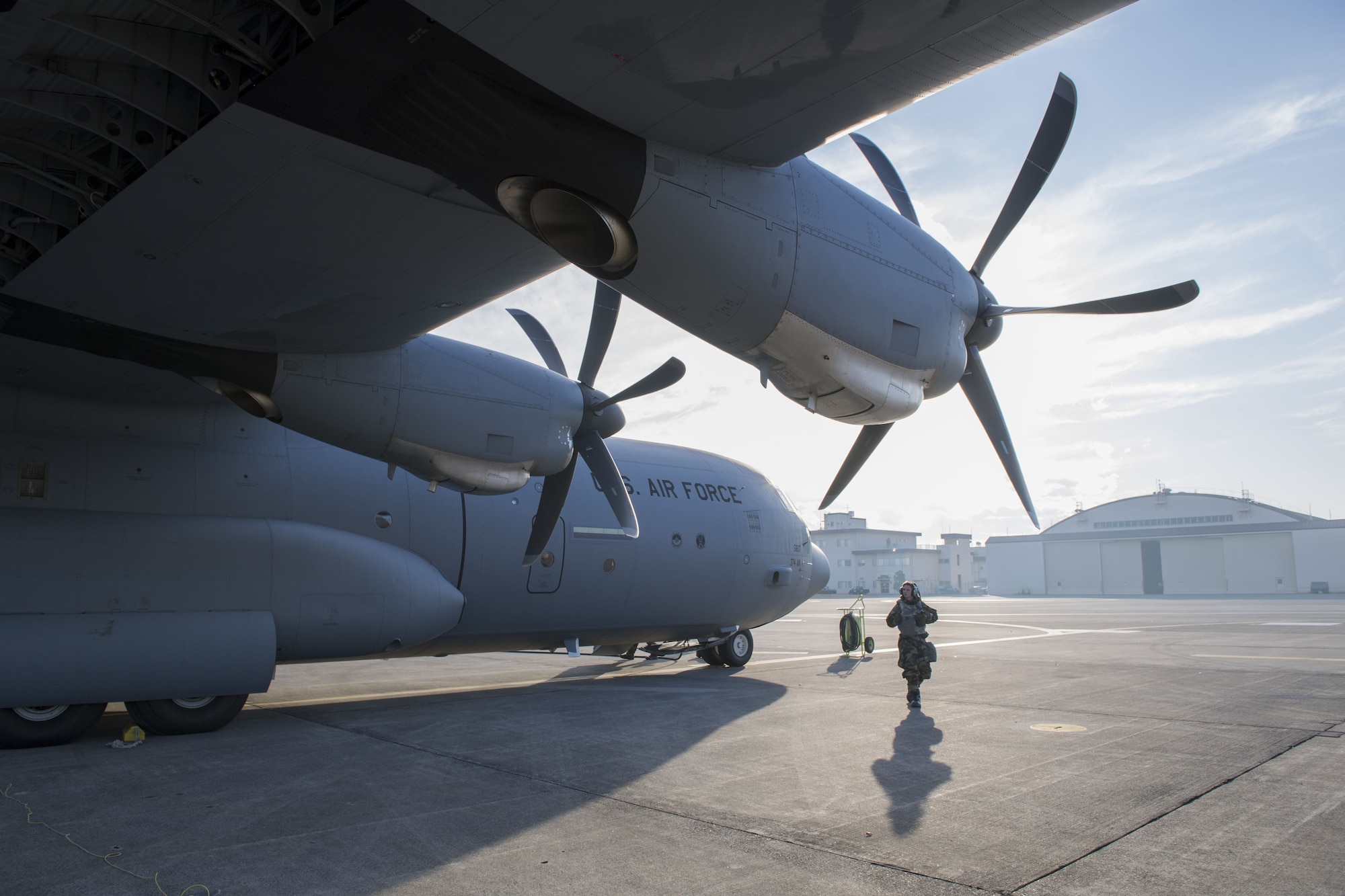 An Airman with the 374th Aircraft Maintenance Squadron performs pre-flight checks prior to starting up a C-130J Super Hercules during exercise Vigilant Ace 18, Dec. 6, 2017, at Yokota Air Base, Japan.