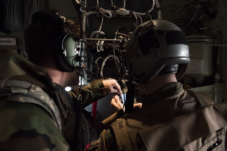 2nd Lt. Robert Havene, 41st Troop Carrier Squadron C-130J Super Hercules pilot, works out a pre-flight issue with an Airmen from the 374th Aircraft Maintenance Squadron during exercise Vigilant Ace 18, Dec. 6, 2017, at Yokota Air Base, Japan.