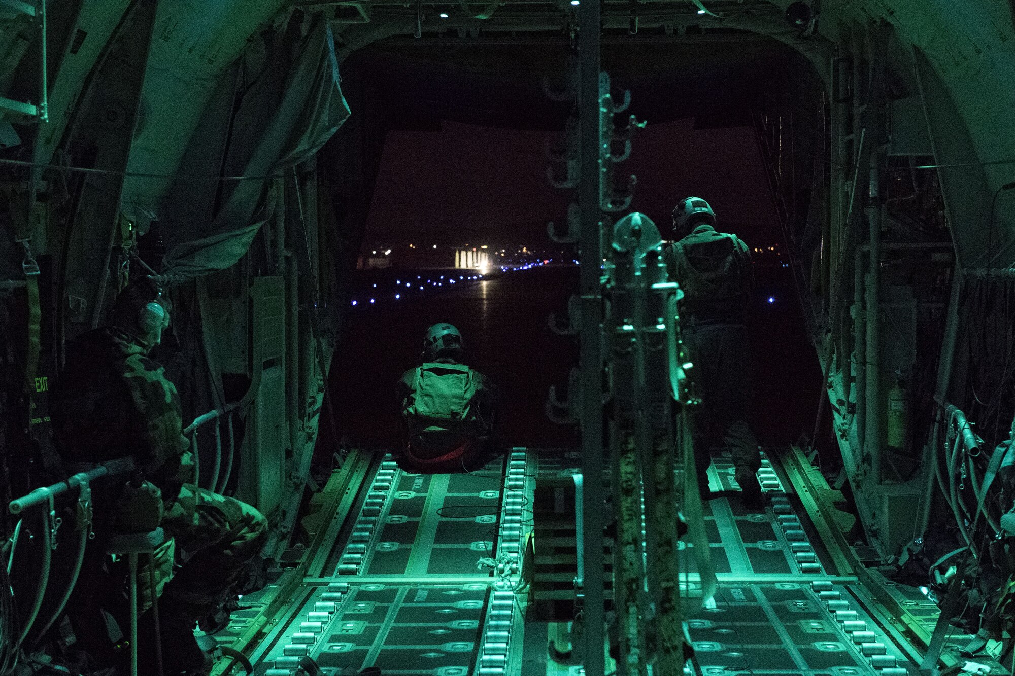 Airmen with the 41st Troop Carrier Squadron from Little Rock Air Force Base, AR, look out the tailgate of a C-130J Super Hercules during exercise Vigilant Ace 18, Dec. 6, 2017, at Osan Air Base, Republic of Korea.