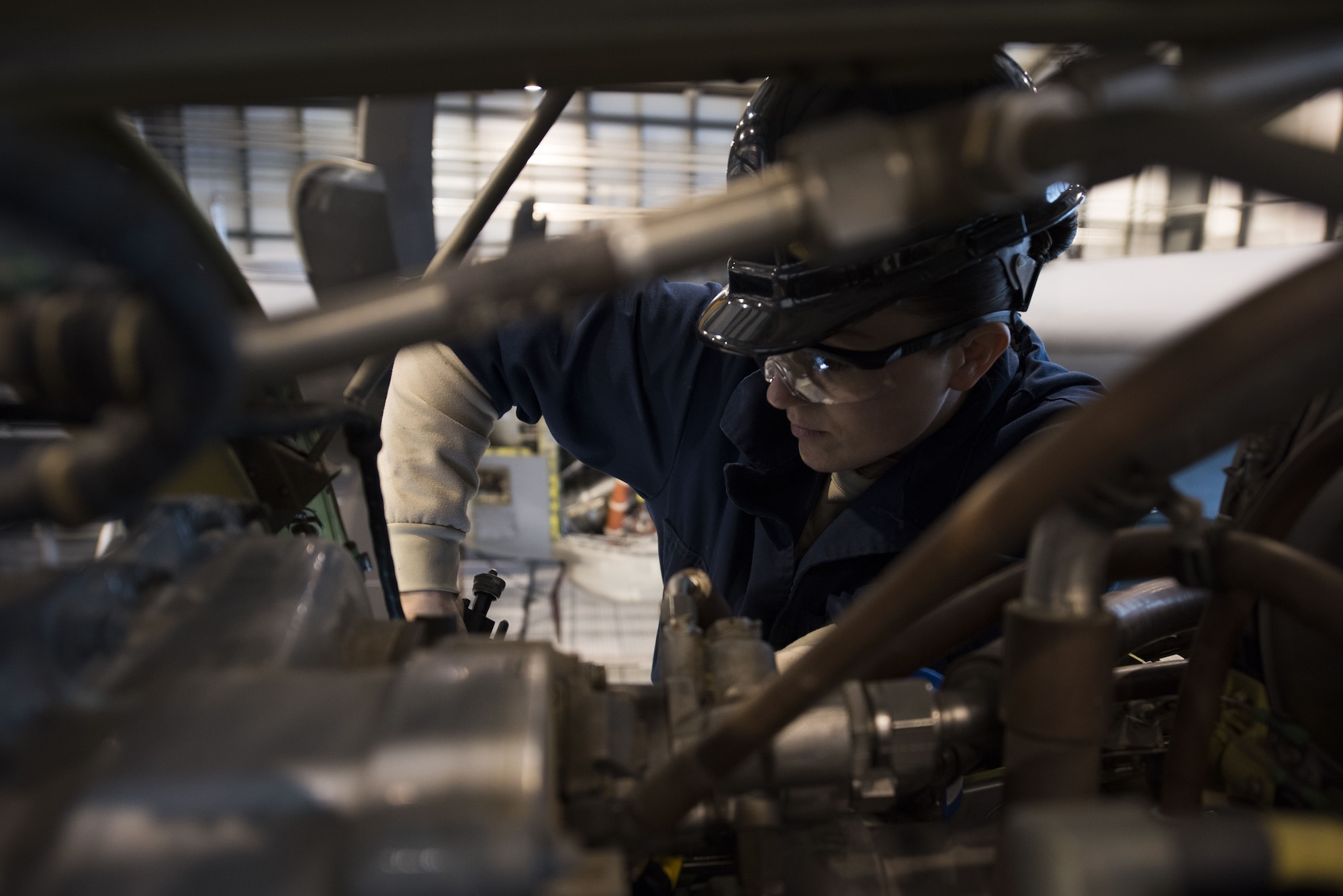 U.S. Air Force Staff Sgt. Lindsay Hallford, 86th Maintenance Squadron C-130J Super Hercules crew chief, works on a C-130J engine during a C1-check on Ramstein Air Base, Germany, Dec. 5, 2017. C1-checks are completed on a set rotation of inspections and time intervals. (U.S. Air Force photo by Senior Airman Devin M. Rumbaugh)