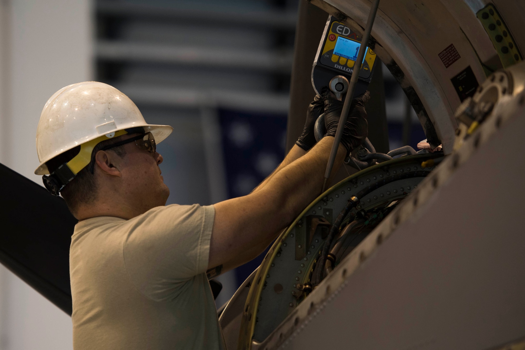 U.S. Air Force Staff Sgt. David Gilliland, 86th Maintenance Squadron aerospace propulsion craftsman, detaches a crane from a C-130J Super Hercules engine during a C1-check on Ramstein Air Base, Germany, Dec. 5, 2017. The maintainers used the crane to prop the engine up, and replaced the parts holding the engine to the aircraft. (U.S. Air Force photo by Senior Airman Devin M. Rumbaugh)