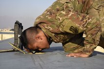 Staff Sgt. Anthony Single, 455th Expeditionary Aircraft Maintenance Squadron crew chief, inspects a C-130J Super Hercules Dec. 5, 2017 at Bagram Airfield, Afghanistan.