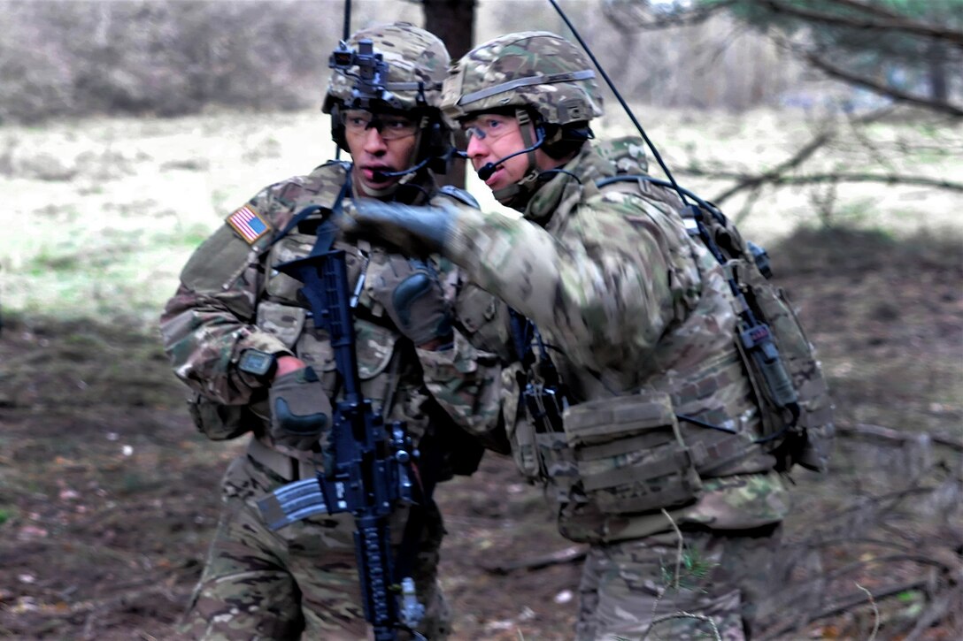 Two soldiers speak to each other.