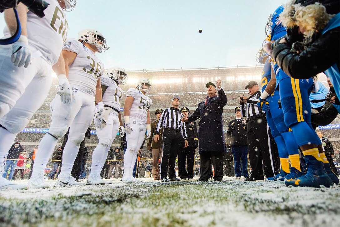 Secretary of State Rex Tillerson tosses the coin before the start of the 118th Army-Navy game.