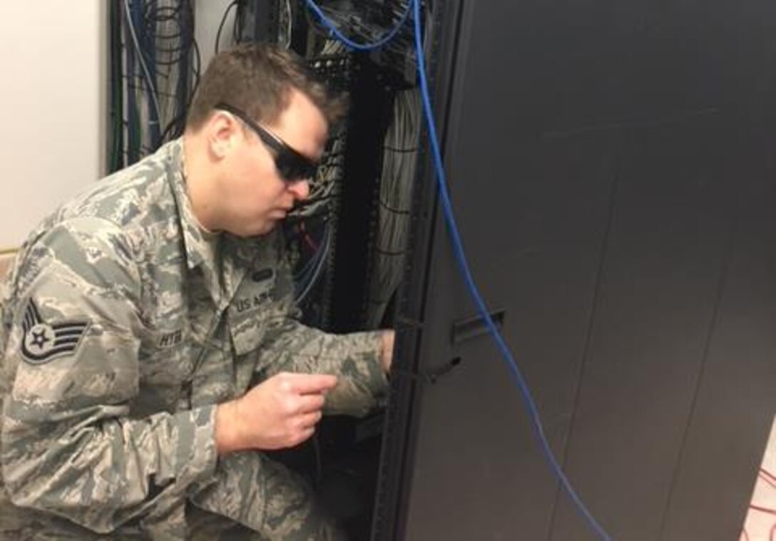 A U.S. Airman conducts upgrade work on command and control systems at Naval Station Rota, Spain, Dec. 8, 2017. Airmen assigned to U.S. Air Forces in Europe and Air Forces Africa, Air Mobility Command, Air Force Space Command, and Air Force Material command joined forces to upgrade the network. (Courtesy photo)