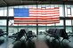 A U.S. flag hangs over the passenger terminal on Ramstein Air Base, Germany, Aug. 14, 2017. Officials assigned to the 86th Airlift Wing encouraged military members and government civilians to stay vigilant while going about their business or taking leisure. (U.S. Air Force photo by Airman 1st Class Joshua Magbanua)