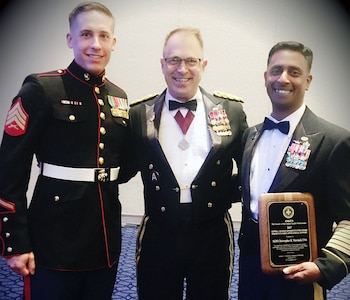 Sgt. Maj. Christopher R. Marshall (right) from the U.S. Army Medical Department Center & School at Joint Base San Antonio-Fort Sam Houston is presented the Lewis L. Seaman Enlisted Award for Outstanding Operational Support in the senior enlisted category from Maj. Gen. Brian C. Lein (center), AMEDDC&S and U.S. Army Health Readiness Center of Excellence commanding general, Nov. 30 at the Potomac Ballroom of the Gaylord National Harbor Resort and Convention Center in Washington D.C. Marshall’s son-in-law, Sgt. Michael Beck (left), U.S. Marine Corps, is also pictured.