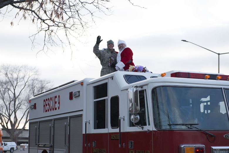Master Sgt. Shawn Houser, 366th Equipment Maintenance Squadron first sergeant, waves and smiles with Santa during the holiday parade Dec. 8, 2017 at Mountain Home Air Force Base, Idaho. The holiday parade visited several areas around the base to include base housing, the child development center and the youth center. (U.S. Air Force photo by Senior Airman Lauren-Taylor Levin)