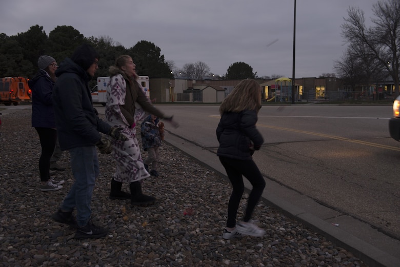 Children catch candy from float participants during the holiday parade Dec. 8, 2017, at Mountain Home Air Force Base, Idaho. The holiday parade visited several areas around the base to include base housing, the child development center and the youth center. (U.S. Air Force photo by Senior Airman Lauren-Taylor Levin)