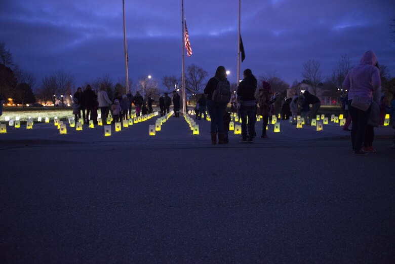 Families of deployed Gunfighters stand and talk to one another during Gunfighter Glow Dec. 8, 2017, at Mountain Home Air Force Base, Idaho. Gunfighter Glow was created to bring to light of the number of Gunfighters that are currently deployed and away from their loved ones during the holiday season. (U.S. Air Force photo by Senior Airman Lauren-Taylor Levin)