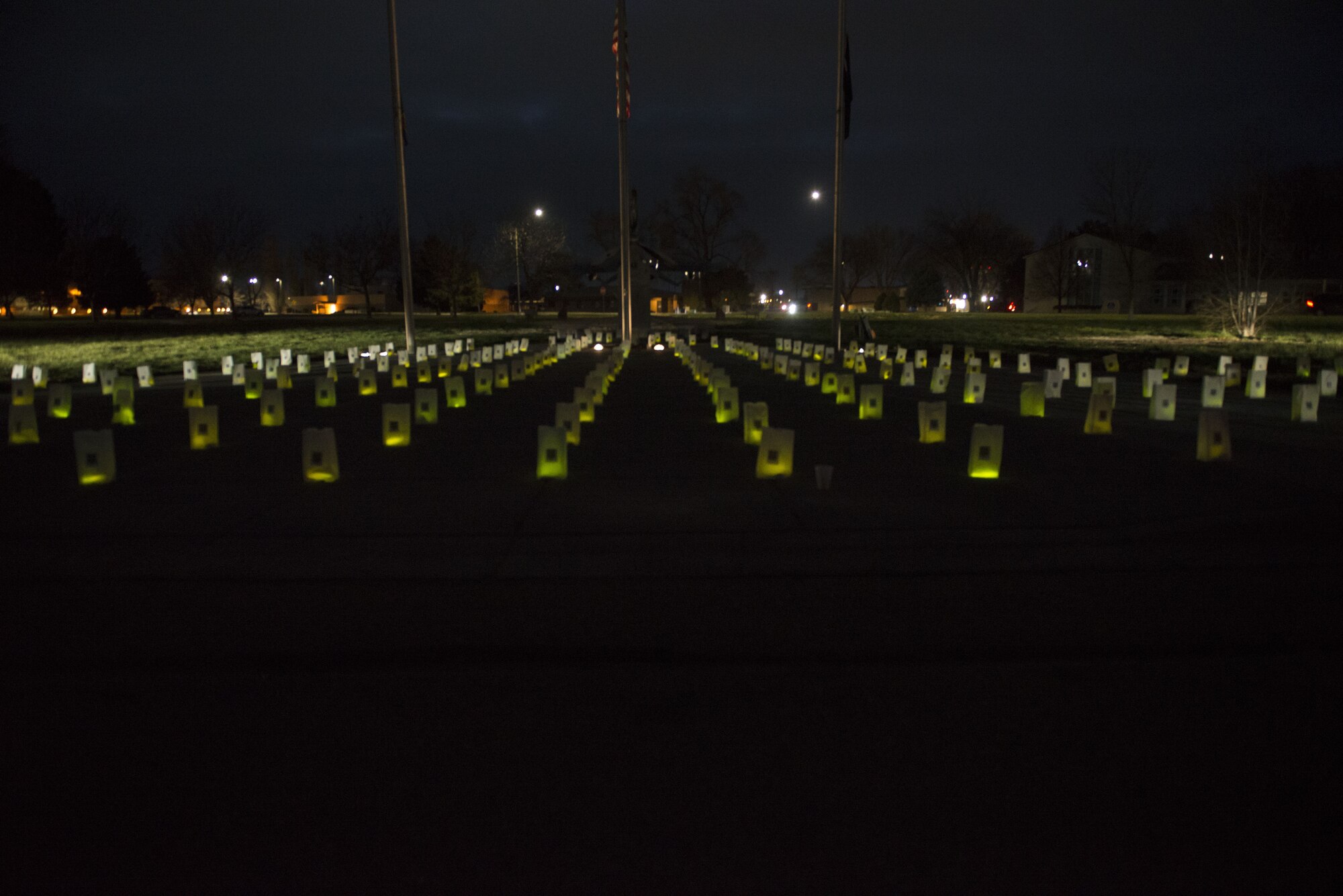 Lit bags glow after Gunfighter Glow on Dec. 8, 2017 at Mountain Home Air Force Base, Idaho. The bags will stay in place during the holiday season to remember all Gunfighters who are currently deployed and away from their loved ones. (U.S. Air Force photo by Senior Airman Lauren-Taylor Levin)
