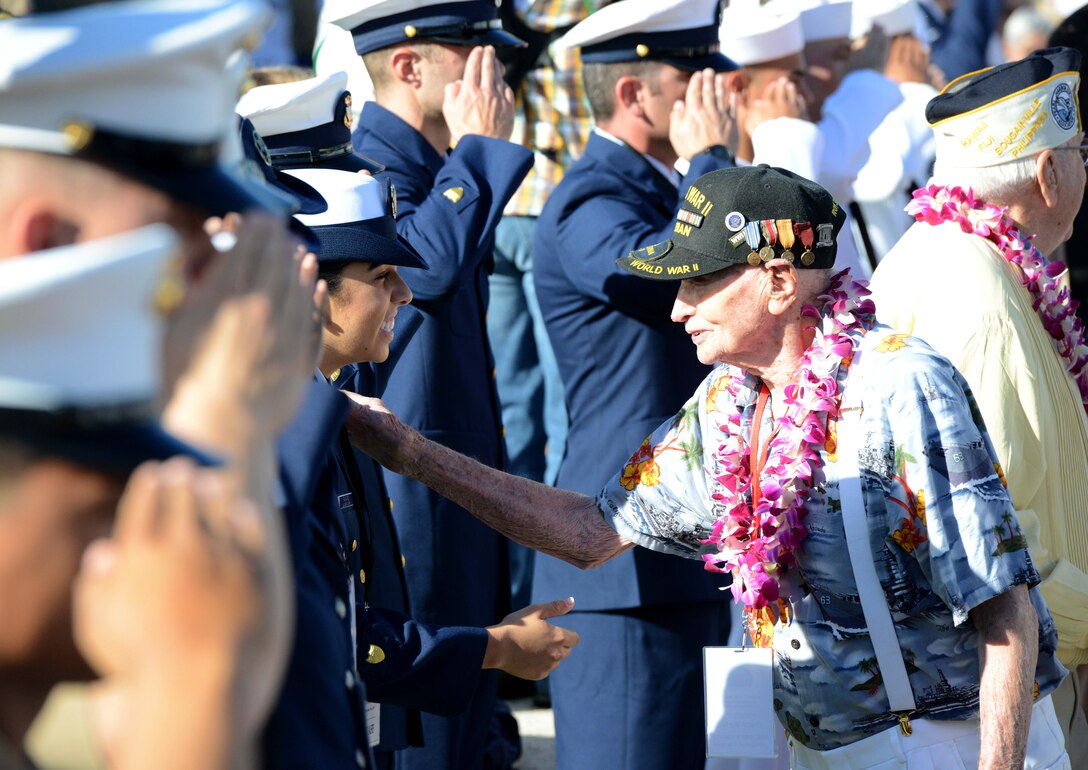 A veteran greets a coast guardsman.