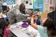 Lt. Col. Joseph Beard, 56th Medical Operations Squadron commander, high-fives a student Nov. 21, 2017, at Luke Elementary School, Glendale, Ariz. Service members visited Luke Elementary School in observance of National Disability Employment Awareness Month.