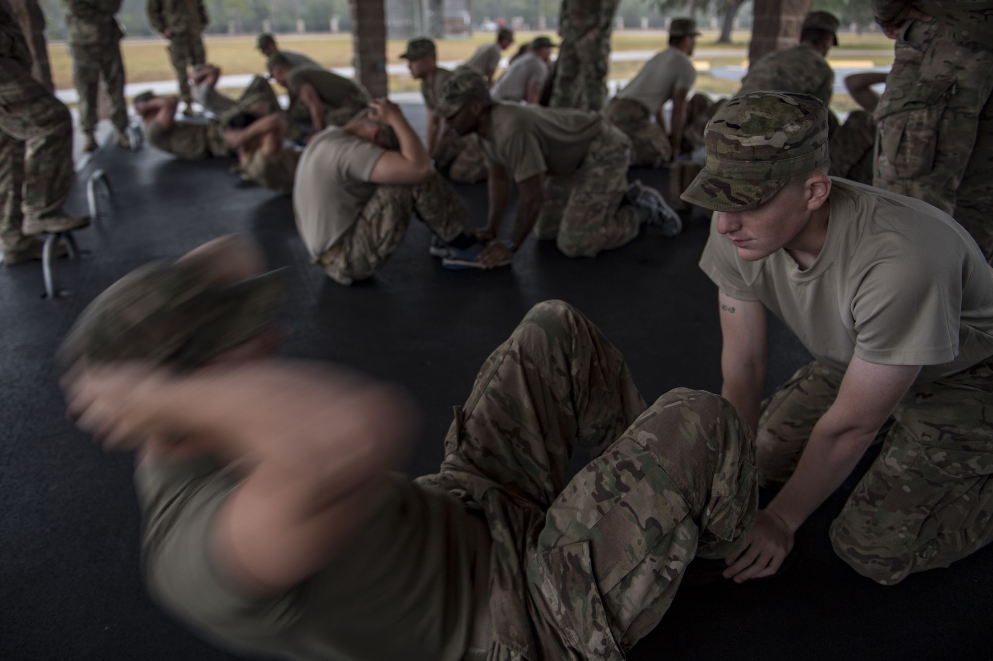 Airmen from the 820th Base Defense Group perform the sit-up portion of the Army Physical Fitness Test during an Army Air Assault readiness assessment, Dec. 7, 2017, at Camp Blanding, Fla. The AAA readiness assessment is designed to prepare Airmen for the Army Air Assault School curriculum as well as its physical and mental stressors. During AAA, U.S. troops are taught an array of skills associated with rotary-winged aircraft. These skills widen the 820th BDG’s ability to swiftly deploy and defend. (U.S. Air Force photo by Senior Airman Daniel Snider)