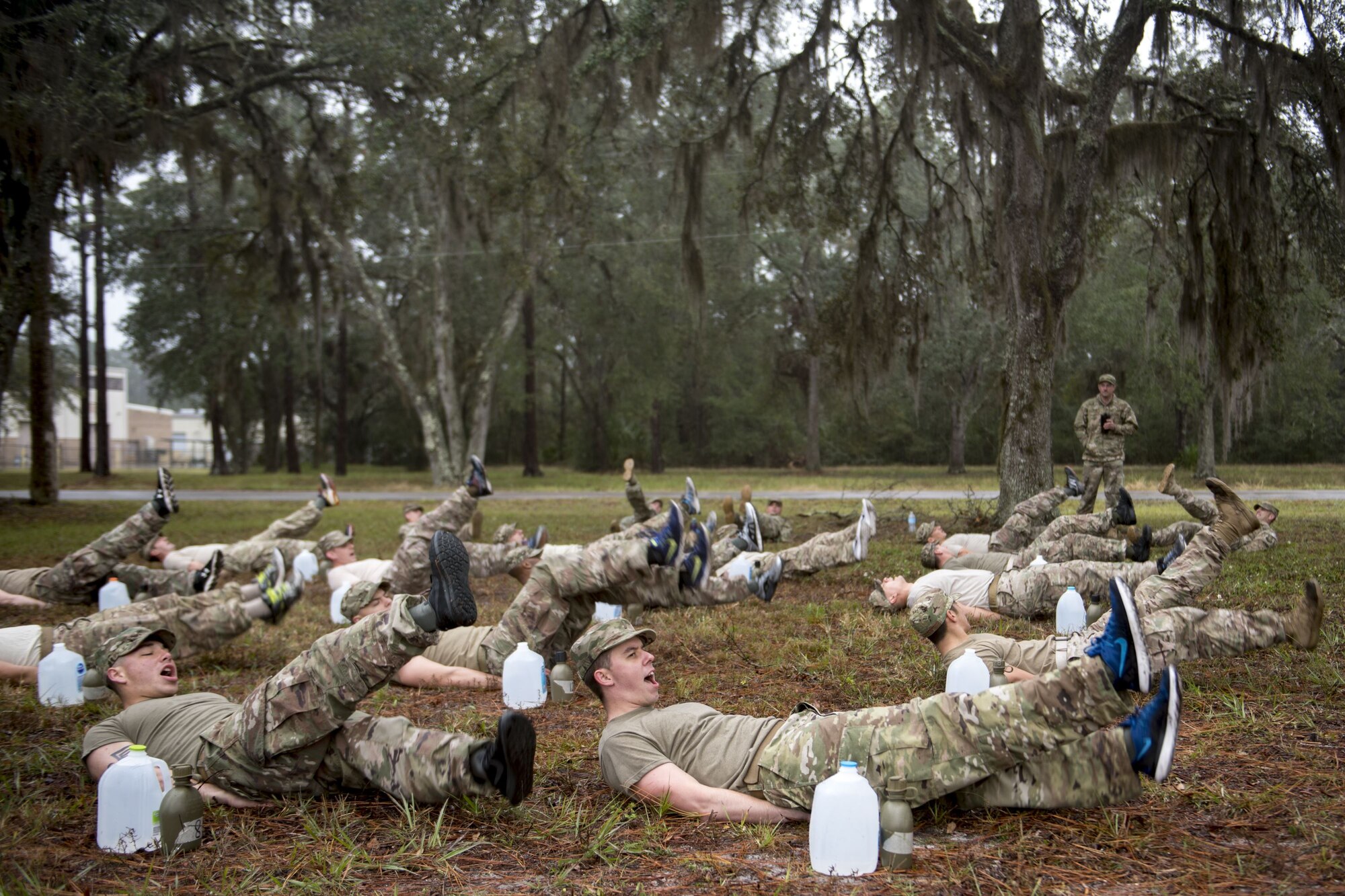 Airmen from the 820th Base Defense Group perform flutter kicks during an Army Air Assault readiness assessment, Dec. 7, 2017, at Camp Blanding, Fla. The AAA readiness assessment is designed to prepare Airmen for the Army Air Assault School curriculum as well as its physical and mental stressors. During AAA, U.S. troops are taught an array of skills associated with rotary-winged aircraft. These skills widen the 820th BDG's ability to swiftly deploy and defend. (U.S. Air Force photo by Senior Airman Daniel Snider)