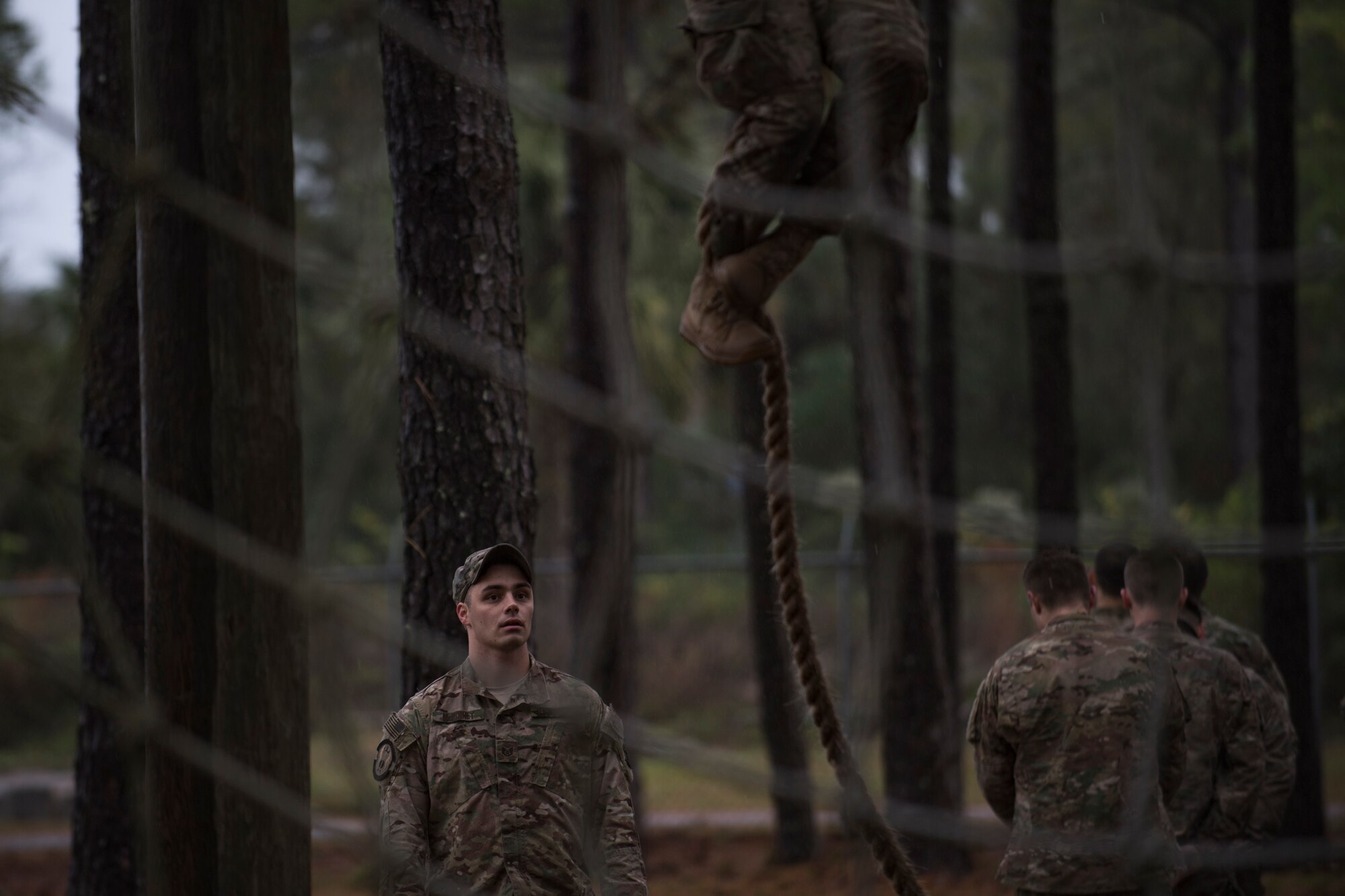 Staff Sgt. James McKinney, 823d Base Defense Squadron fireteam leader and cadre team member, watches candidates attempt an obstacle during an Army Air Assault readiness assessment, Dec. 7, 2017, at Camp Blanding, Fla. The AAA readiness assessment is designed to prepare Airmen for the Army Air Assault School curriculum as well as its physical and mental stressors. During AAA, U.S. troops are taught an array of skills associated with rotary-winged aircraft. These skills widen the 820th Base Defense Group’s ability to swiftly deploy and defend. (U.S. Air Force photo by Senior Airman Daniel Snider)