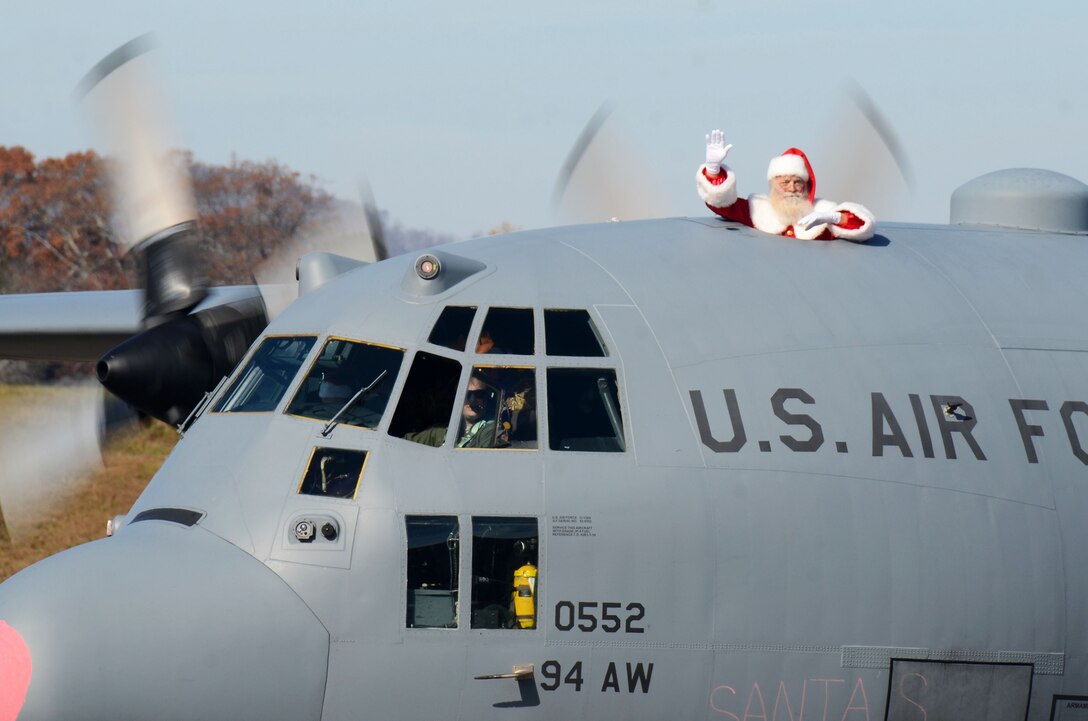 Santa Clause waves from a C-130H3 Hercules as it taxis on the runway at Dobbins Air Reserve Base, Ga. Dec. 3, 2017. Santa visited Dobbins during the December drill weekend and met with reservists and their family members to hear holiday wishes. (U.S. Air Force photo by Don Peek)