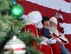Mr. and Mrs. Santa Clause listen as a military family member tells them his holiday wishes at Dobbins Air Reserve Base, Ga. Dec. 3, 2017. The Clauses visited Dobbins as part of this year's Operation Santa Lift. (U.S. Air Force photo by Don Peek)