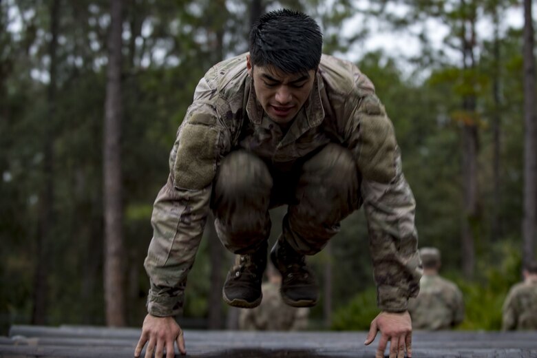 Airman Tyler Carpenter, 823d Base Defense Squadron fireteam member, leaps over a log obstacle during an Army Air Assault readiness assessment, Dec. 7, 2017, at Camp Blanding, Fla. The AAA readiness assessment is designed to prepare Airmen for the Army Air Assault School curriculum as well as its physical and mental stressors. During AAA, U.S. troops are taught an array of skills associated with rotary-winged aircraft. These skills widen the 820th Base Defense Group’s ability to swiftly deploy and defend. (U.S. Air Force photo by Senior Airman Daniel Snider)