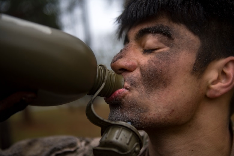 Airman Tyler Carpenter, 823d Base Defense Squadron fireteam member, drinks from his canteen after finishing the last obstacle during an Army Air Assault readiness assessment, Dec. 7, 2017, at Camp Blanding, Fla. The AAA readiness assessment is designed to prepare Airmen for the Army Air Assault School curriculum as well as its physical and mental stressors. During AAA, U.S. troops are taught an array of skills associated with rotary-winged aircraft. These skills widen the 820th Base Defense Group’s ability to swiftly deploy and defend. (U.S. Air Force photo by Senior Airman Daniel Snider)