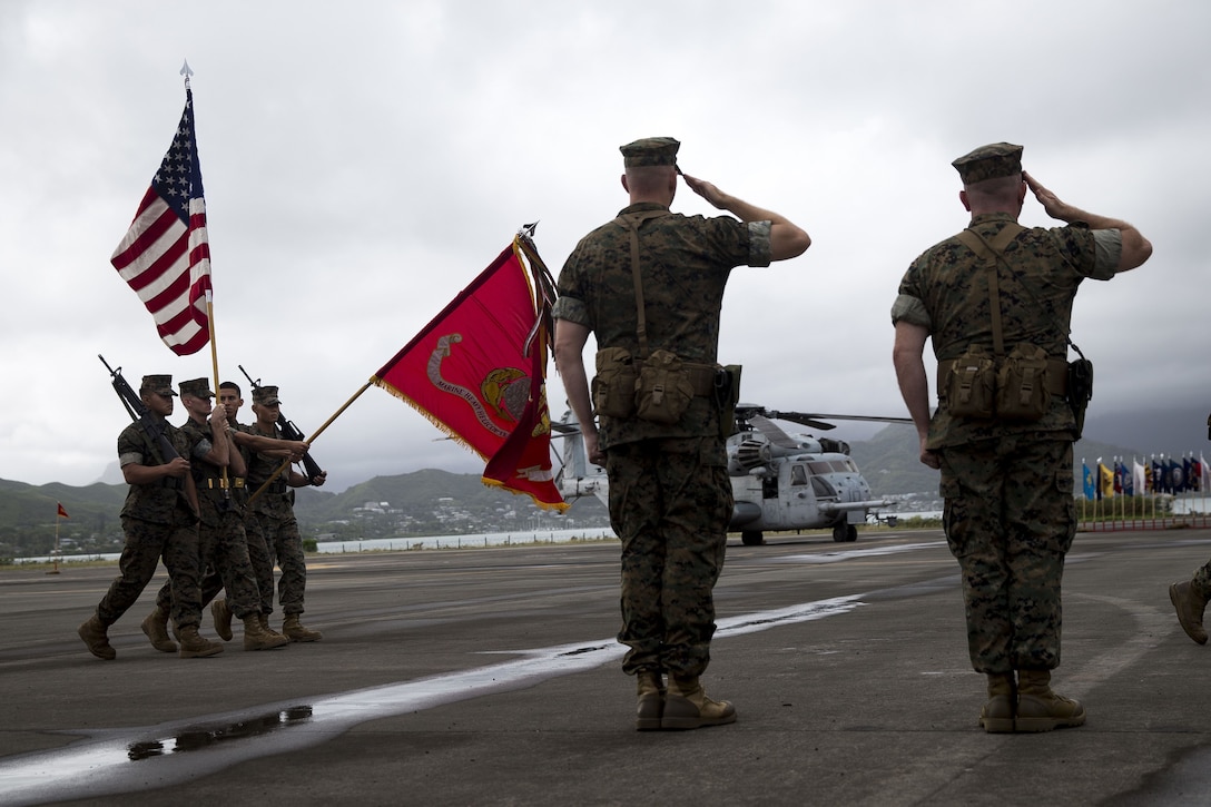 U.S. Marine Corps Lt. Col. Eric D. Purcell, off-going commanding officer, Marine Heavy Helicopter Squadron 463, and U.S. Marine Corps Lt. Col. Kevin G. Hunter, on-coming commanding officer, salute the colors during the Marine Heavy Helicopter Squadron 463 Change of Command aboard Marine Corps Base Hawaii, Dec. 1, 2017. Lt. Col. Eric D. Purcell relinquished command of the squadron to Lt. Col. Kevin G. Hunter during the ceremony. (Marine Corps Photo by Sgt. Alex Kouns/Released)