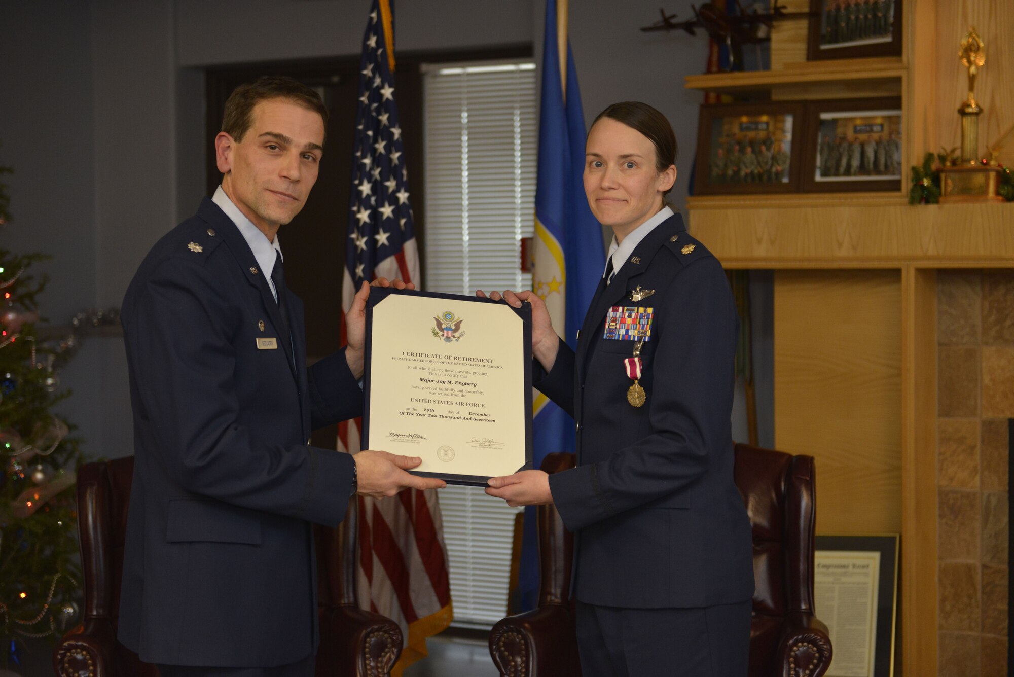 Maj. Joy Engberg, right, receives her certificate of retirement from Lt. Col. Chris Sedlacek, 934th Operations Group commander,  at the Minneapolis-St. Paul Air Reserve Station, Minn., on Dec. 2, 2017. (U.S. Air Force photo by Staff Sgt. Amber E. N. Jacobs)