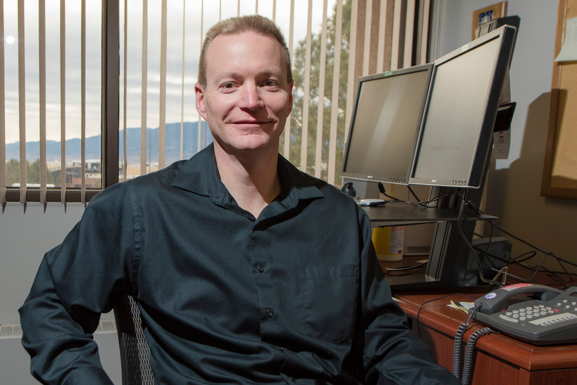 Jeff Wiseheart, 21st Operations Group, technical director, one of four civilians interviewed, works at his desk at Peterson Air Force Base, Colorado, Dec 7, 2017. The 21st Space Wing employees over 1,000 civilians in support of its global mission. (U.S. Air Force photo by Senior Airman Dennis Hoffman)