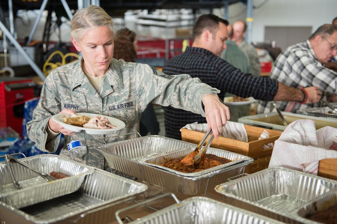 Senior Master Sgt. Jen Murphy, flight chief at the 96th Airlift Squadron, enjoys food at the holiday party for the 96th Airlift Squadron on December 2. (U.S. Air Force photo by Tech. Sgt. Trevor Saylor)