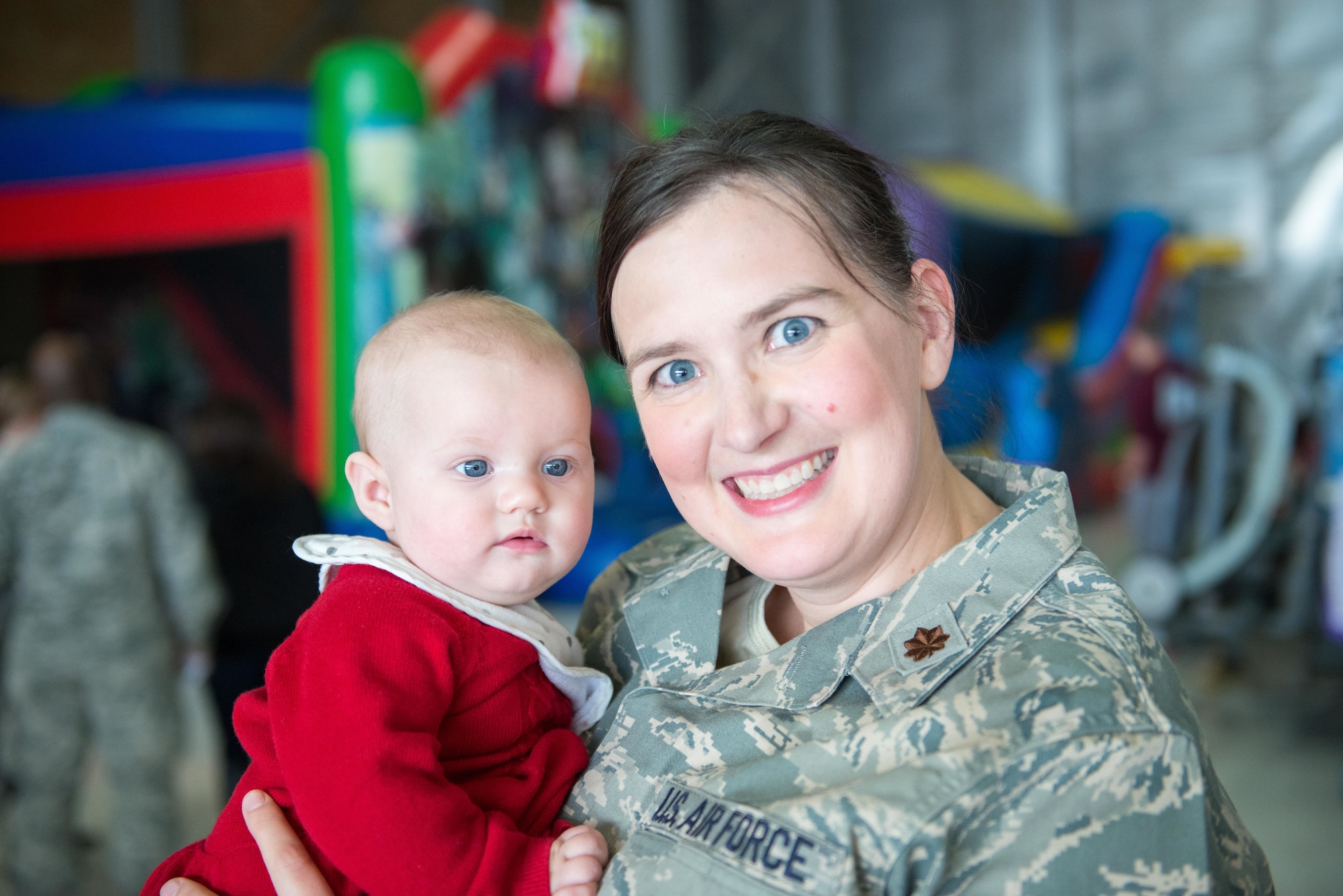 Major Christine Schroeder poses with her daughter, Charlotte, at the holiday party for the 96th Airlift Squadron on December 2. (U.S. Air Force photo by Tech. Sgt. Trevor Saylor)