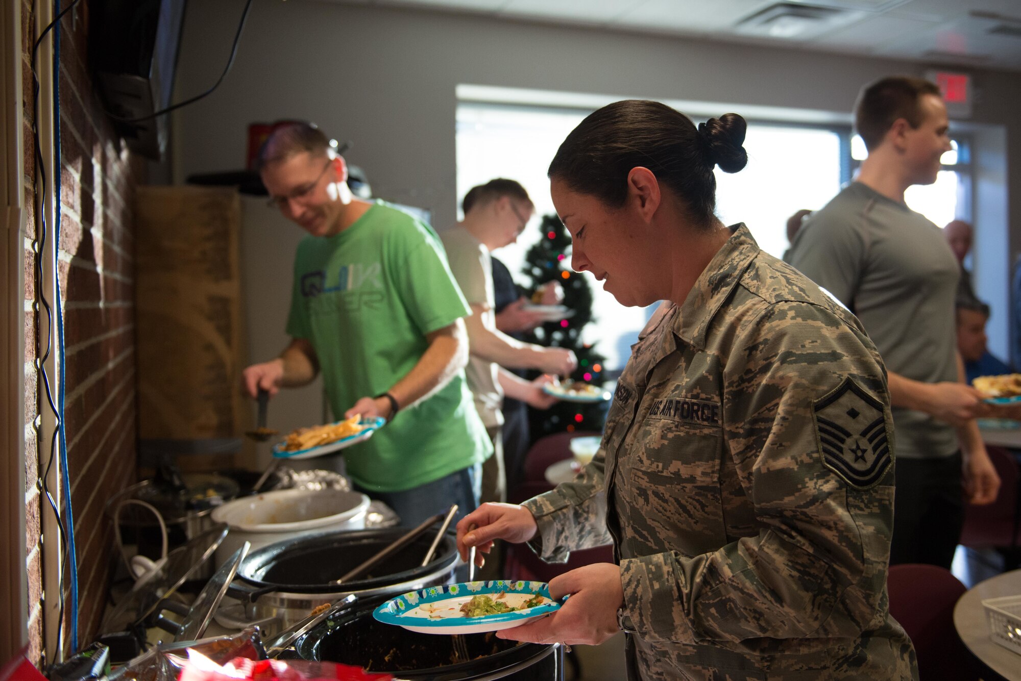 Master Sgt. Angela Hermanson, 934th Communications Squadron First Sergeant, enjoys food at the holiday party for the 934th Communications Squadron on December 2. (U.S. Air Force photo by Tech. Sgt. Trevor Saylor)