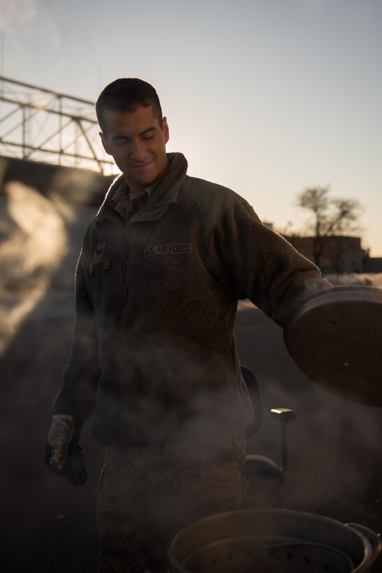 Senior Airman David Chilson, Heavy Equipment Operator at the 934th Civil Engineering Squadron, checks on the deep fried turkey at the holiday party for the 934th Civil Engineering Squadron on December 2. (U.S. Air Force photo by Tech. Sgt. Trevor Saylor)