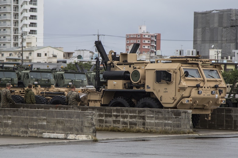CAMP FOSTER, OKINAWA, Japan –Marines wash a MKR18 Logistic Vehicle System Replacement Dec. 1 at the 3rd Transport Support Battalion Motor Pool aboard Camp Foster, Okinawa, Japan.