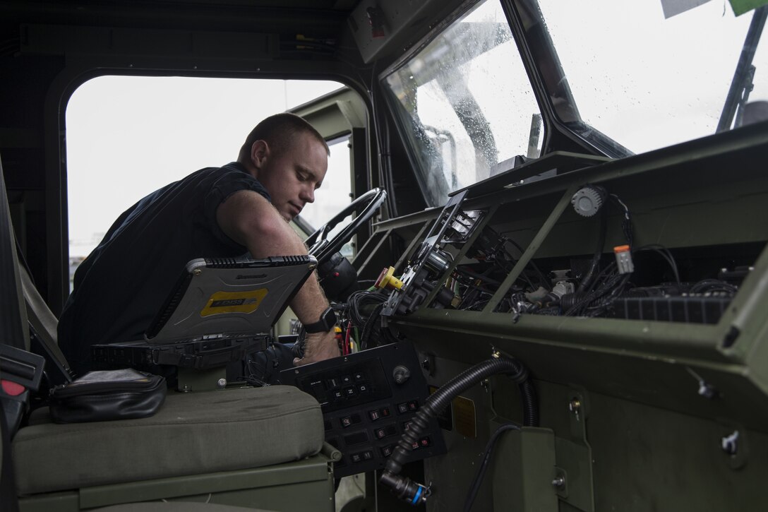 CAMP FOSTER, OKINAWA, Japan – Cpl. Ryan Simmons tests the electrical components of a dashboard in a wrecker Dec. 1 at the 3rd Transport Support Battalion Motor Pool aboard Camp Foster, Okinawa, Japan.