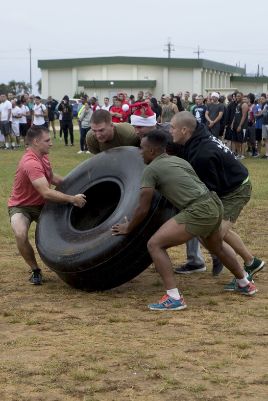 MCAS FUTENMA, OKINAWA, Japan- Marines compete in sleigh pit stop during the Annual Jingle Bell Challenge Dec. 1 on Marine Corps Air Station Futenma, Okinawa, Japan.