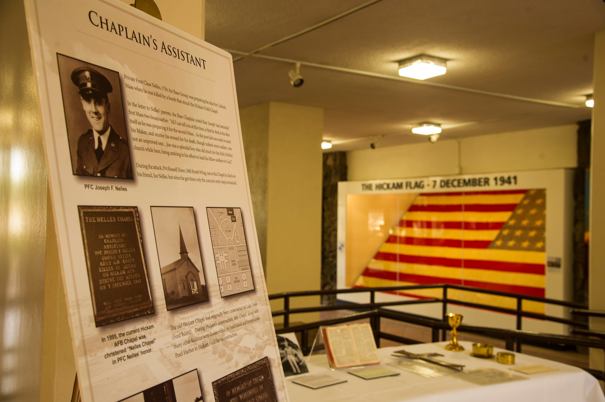 A display features mementos of Airmen who passed during the 1941 attack on Hickam Field at the Courtyard of Heroes in the Pacific Air Forces headquarters building, Joint Base Pearl Harbor-Hickam, Hawaii, Dec. 10, 2017.  A remembrance ceremony was held at the courtyard for U.S. Army Air Corps Pfc. Joseph Nelles, a chaplain’s assistant, who was killed while setting up for a Catholic Mass during the attack. (U.S. Air Force photo by Tech. Sgt. Heather Redman)