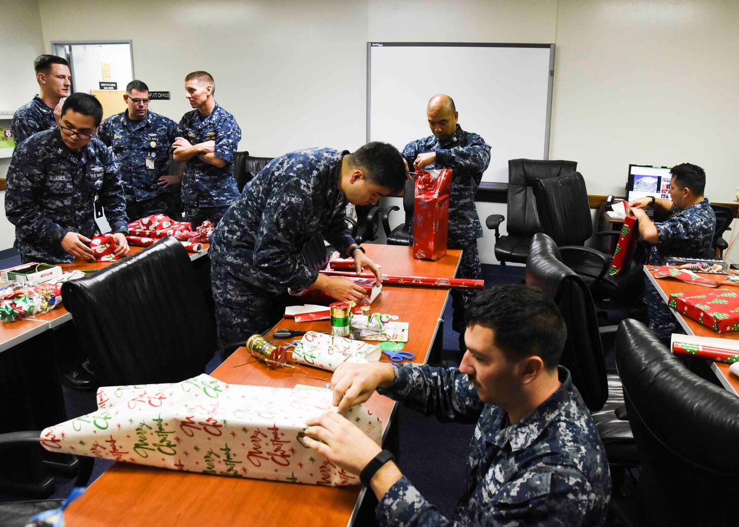 Sailors, assigned to Commander Submarine Group 7, wrap gifts intended for less fortunate children in Yokohama, Japan. The Submarine Group 7 First Class Petty Officer Association participated in a holiday gift drive for 64 underprivileged children in the Yokohama area.